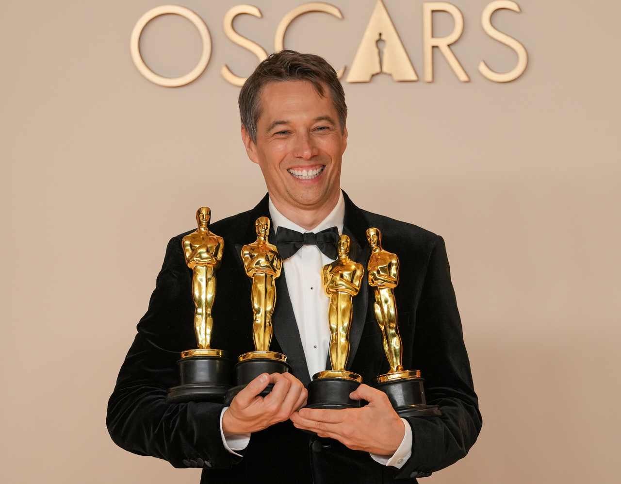 Sean Baker of "Anora" celebrates backstage after winning Oscars for best original screenplay, best film editing, best director, and best picture during the 97th Academy Awards in the Hollywood section of Los Angeles on Sunday. (UPI-Yonhap)