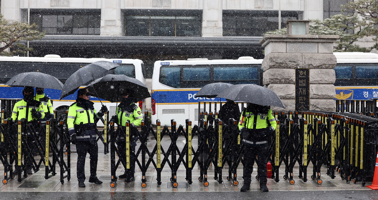 Barricades, police buses and police officials are stationed in front of the Constitutional Court of Korea on Tuesday. A verdict for Yoon’s failed martial law attempt is expected to be announced mid-March. (Yonhap)