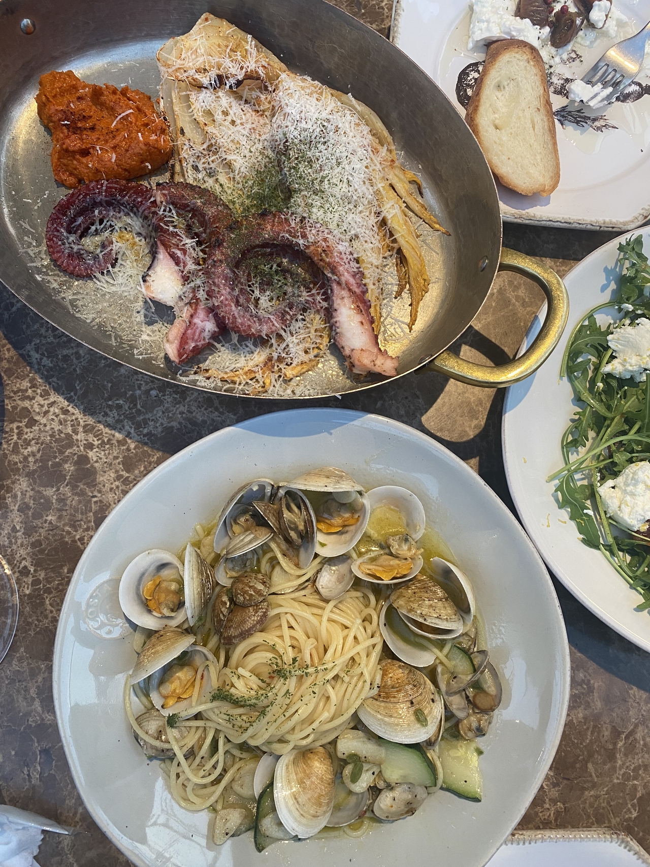 Grilled octopus with romesco sauce (top) and spaghetti alle vongole served at Arch Seoul (Lee Yoon-seo/The Korea Herald)