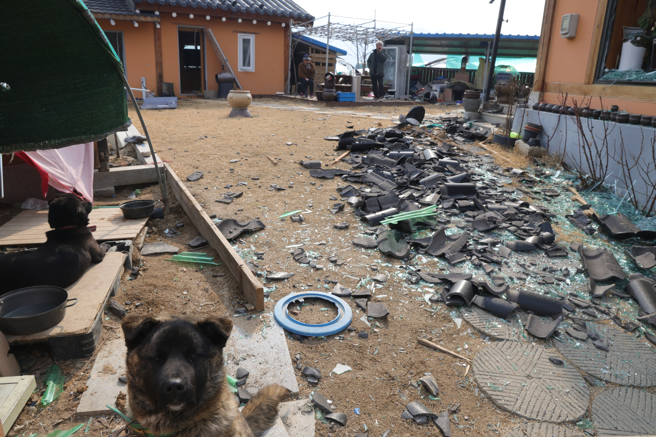 Debris is scattered near a damaged home (Yonhap)