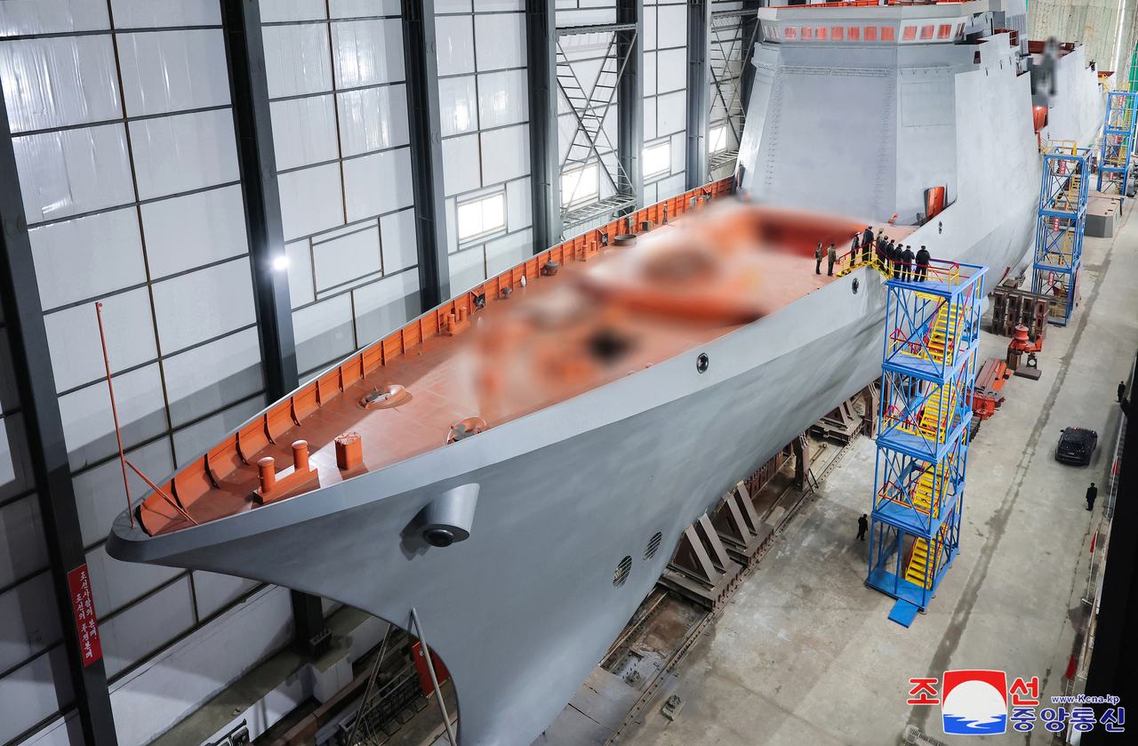 This photo, carried by North Korea's official Korean Central News Agency on March 8, 2025, shows leader Kim Jong-un visiting a major shipyard to inspect the progress of building a nuclear-powered submarine. (Yonhap)