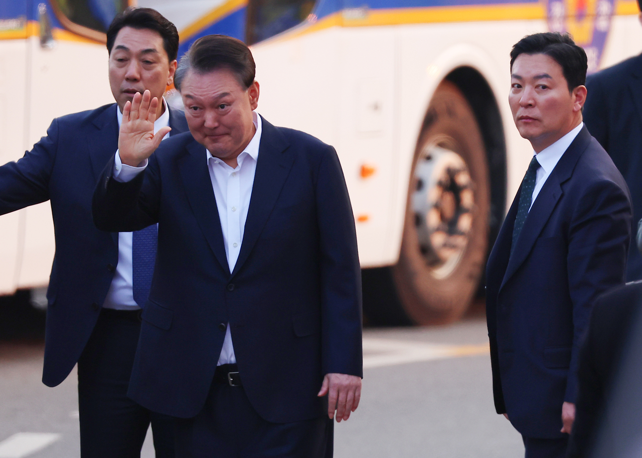 석방된 윤석열 대통령이 8일 경기도 의왕시 서울구치소 앞에서 지지자들에게 인사하고 있는 가운데 그 옆으로 윤 대통령을 경호하고 있는 김성훈 경호처 차장(사진 오른쪽)의 모습이 보인다. [연합]