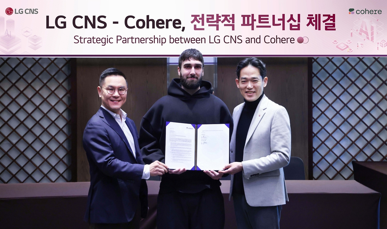 From left: Min Se-hoon, an official from LG CNS, Cohere CEO Aidan Gomez and Chin Yo-han, head of the artificial intelligence center at LG CNS (LG CNS)