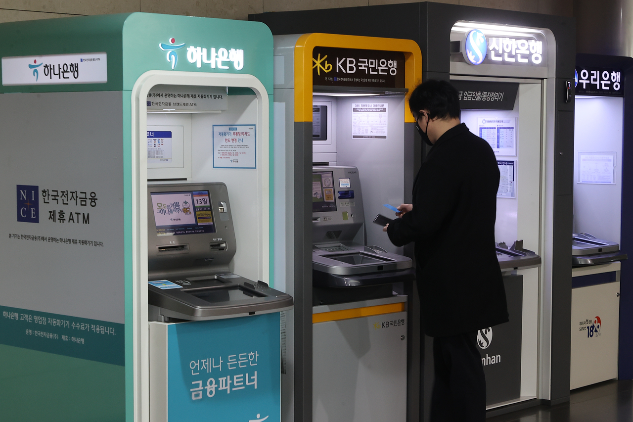 5대 은행의 대표 정기예금 상품의 최고금리가 모두 2%대로 내려앉았다. 사진은 서울 시내에 설치된 현금자동입출금기(ATM)에서 시민들이 은행 업무를 보고 있는 모습 [연합]