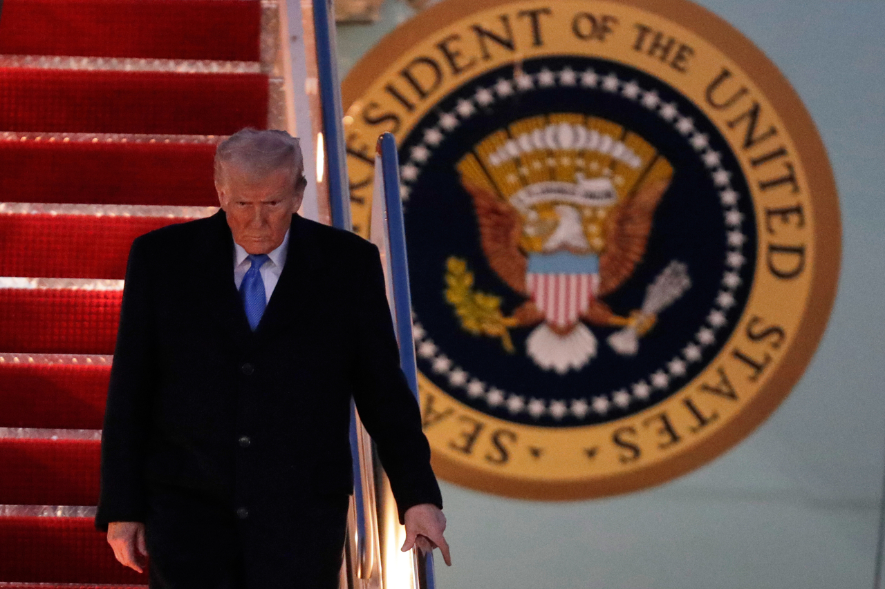 US President Donald Trump walks down the stairs of Air Force One upon his arrival at Joint Base Andrews in Maryland on Sunday. (AP-Yonhap)