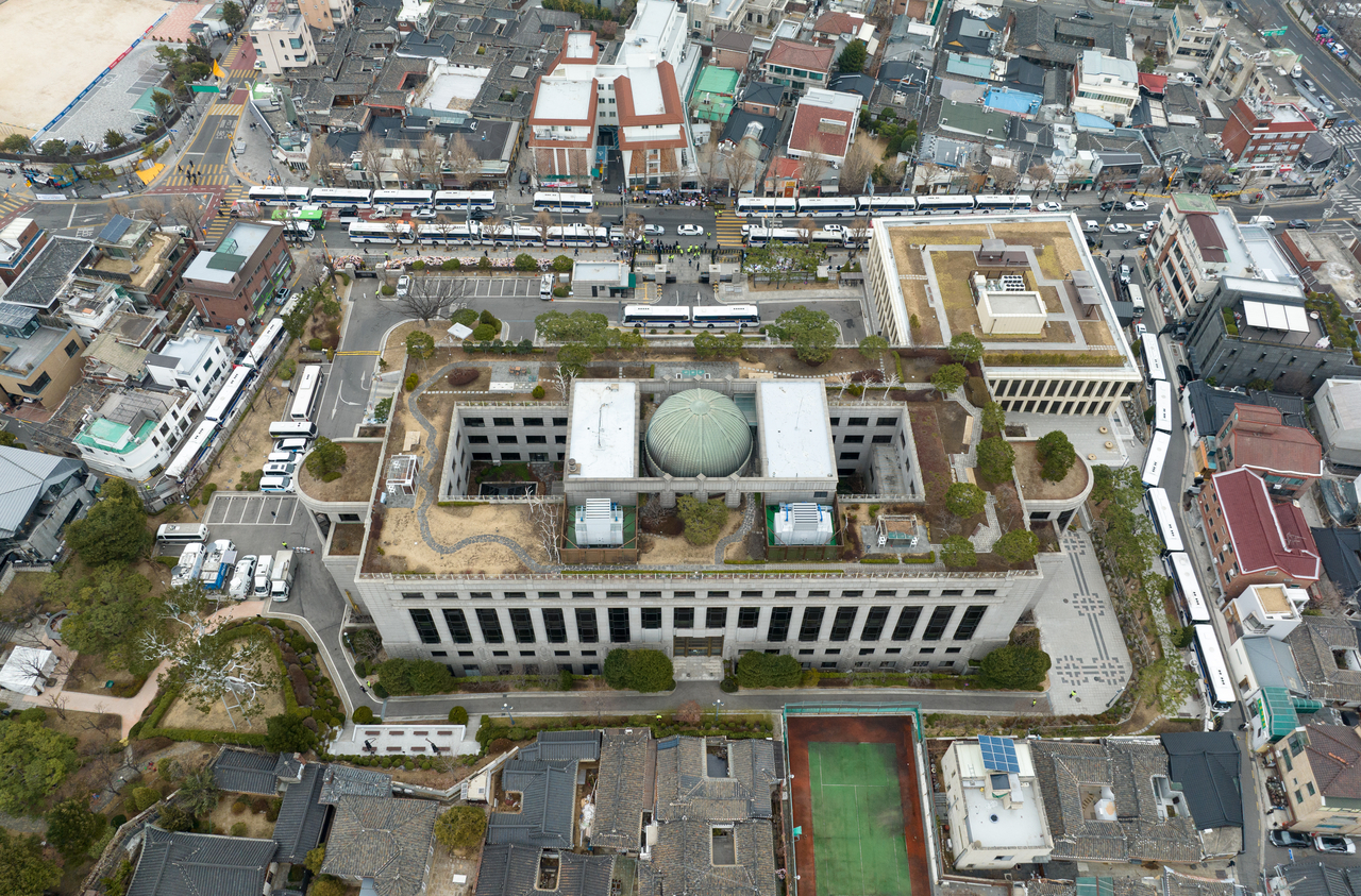 An aerial shot of the Constitutional Court of Korea building surrounded by police buses in Jongno-gu, Seoul, Tuesday. (Yonhap)