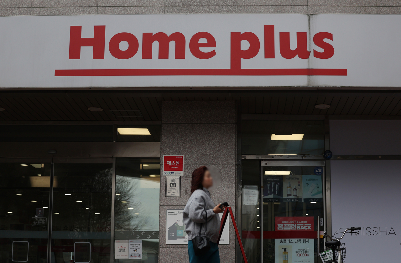 A woman walks by a Homeplus store in Seoul. (Newsis)